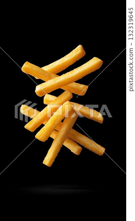 Potato stick fries floating on air with black vertical background Potato stick fries floating on air with black vertical background 132319645