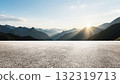 Wide asphalt road under sunset sunlight and distant mountains background 132319713