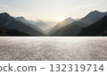 Wide asphalt road under sunset sunlight and distant mountains background 132319714