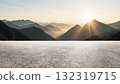 Wide asphalt road under sunset sunlight and distant mountains background 132319715