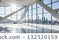 The interior space with glass curtain wall and steel structure offers a view of the city skyline 132320159