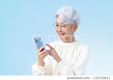Senior female looking at a smartphone Senior female looking at a smartphone 132320611
