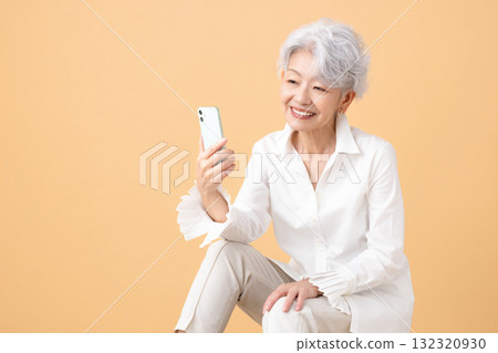 Senior woman with gray hair looking at her smartphone Senior woman with gray hair looking at her smartphone 132320930