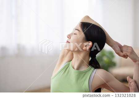 Middle-aged woman doing yoga poses on a yoga mat 132321028