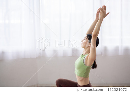 Middle-aged woman doing yoga poses on a yoga mat Middle-aged woman doing yoga poses on a yoga mat 132321072