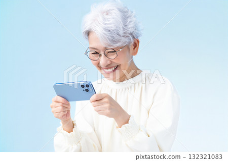 Senior female looking at a smartphone 132321083