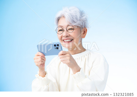 Senior female looking at a smartphone 132321085