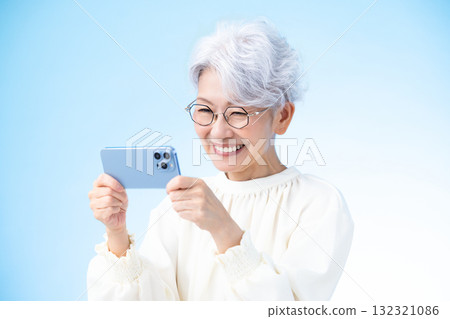 Senior female looking at a smartphone Senior female looking at a smartphone 132321086