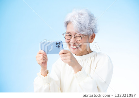 Senior female looking at a smartphone Senior female looking at a smartphone 132321087