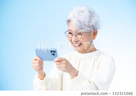 Senior female looking at a smartphone 132321088