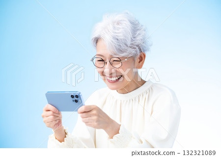 Senior female looking at a smartphone Senior female looking at a smartphone 132321089