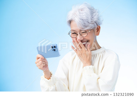 Senior female looking at a smartphone 132321090