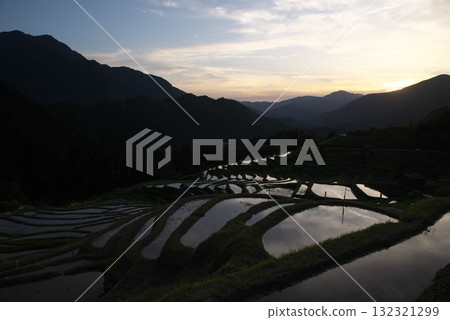 Sunset reflected on rice terraces Sunset reflected on rice terraces 132321299