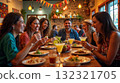 Friends enjoying mexican food and margaritas at restaurant 132321705