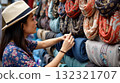 Tourist choosing colorful scarves at street market in Asia 132321707