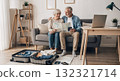 Senior couple planning vacation looking at map and holding passport 132321714