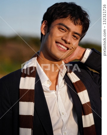 Elegant young businessman smiling and posing outdoors 132321716