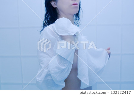 A woman wearing a white shirt after taking a bath A woman wearing a white shirt after taking a bath 132322417