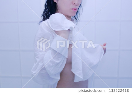 A woman wearing a white shirt after taking a bath A woman wearing a white shirt after taking a bath 132322418