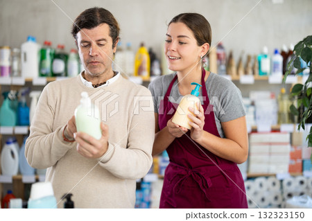 Female consultant helps man buyer choose liquid hand soap 132323150