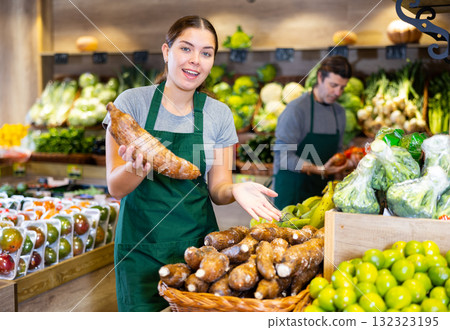 Young woman selling cassava in shop 132323195
