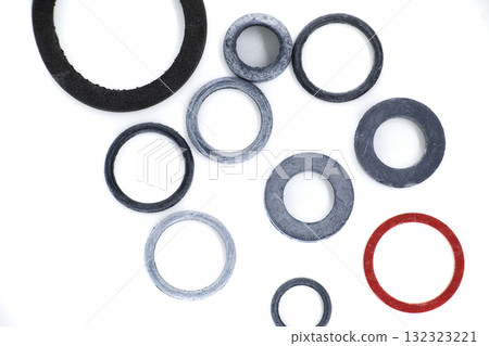 Assorted rubber rings and gaskets arranged on a white surface in a top-down, detailed view. 132323221