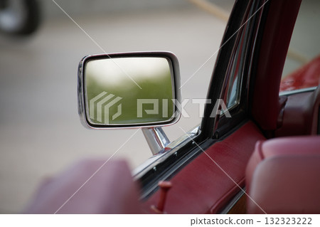 Side Mirror View of a Classic Car with Vibrant Red Interior 132323222