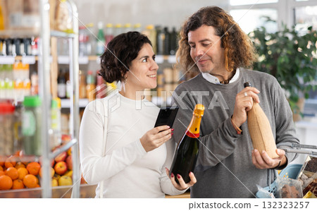 Couple get acquainted with food, scan QR code, take reading red wine label using phone camera 132323257