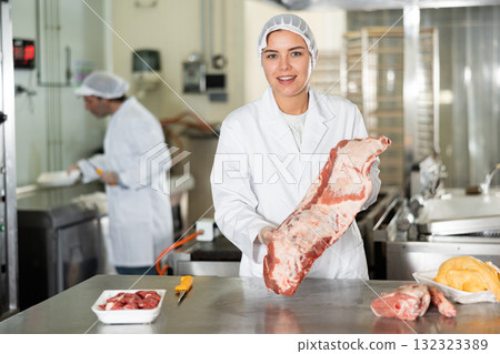 Woman seller demonstration quality porks in butcher supermarket Woman seller demonstration quality porks in butcher supermarket 132323389