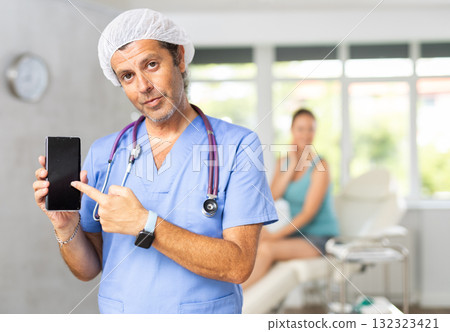 Doctor holding smartphone 132323421