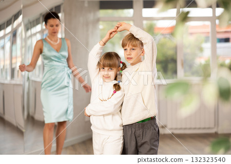 Boy with girl dressed in sport wear train to dance waltz during classes. Boy with girl dressed in sport wear train to dance waltz during classes. 132323540