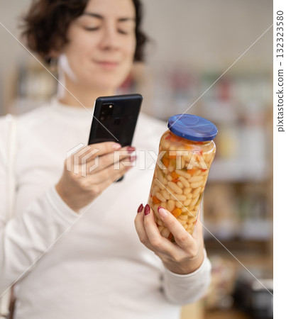 Adult woman scanning qr code of beans Adult woman scanning qr code of beans 132323580
