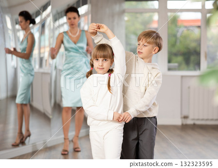 Boy with girl dressed in sport wear train to dance waltz during classes. Boy with girl dressed in sport wear train to dance waltz during classes. 132323595