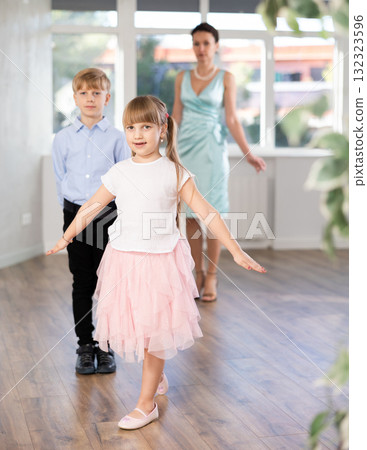 Boy and girl in pair train to dance contemporary vigorous hustle during classes. 132323596