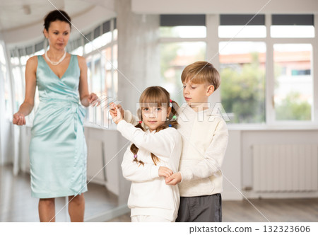 Boy with girl dressed in sport wear train to dance waltz during classes. Boy with girl dressed in sport wear train to dance waltz during classes. 132323606