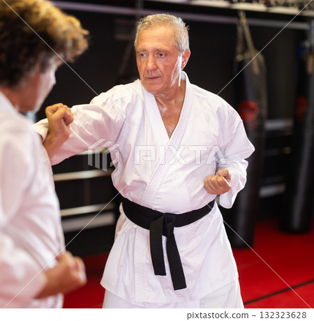 Karate with male athletes practicing, training and sparring in fight class 132323628