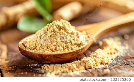 ashwagandha root powder on a wooden spoon, softly lit with warm tones. The natural texture and earthy color convey a sense of organic wellness and adaptogenic nutrition 132325200