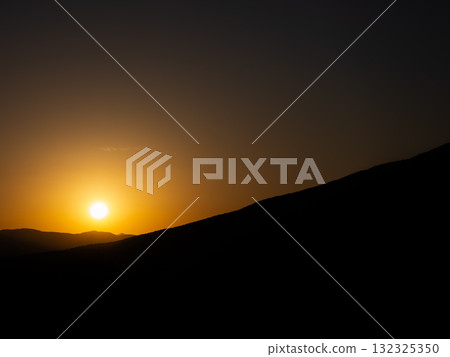 Beautiful scenery of the orange sunset and majestic nature seen from the plateau 132325350