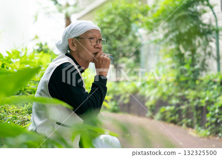 A man in knickerbockers smoking a cigarette 132325500