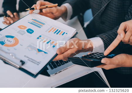 Accounting company provide finance and taxation planning for profitable cash flow, Auditor and accountant team working in office, analyze financial data and accounting record with calculator.Insight 132325620
