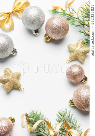 Christmas ornaments and pine branches framing blank space 132325823