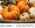 Close-up of decorative pumpkins in woven basket at store display. Autumn harvest seasonal decoration for Thanksgiving holiday. 132325872