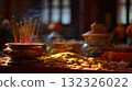 Incense Sticks Burning beside Gold Coins in a Serene Temple Setting 132326022