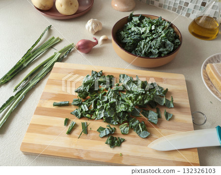 Peeled kale on wooden board at home. Healthy eating, farm produce. Peeled kale on wooden board at home. Healthy eating, farm produce. 132326103