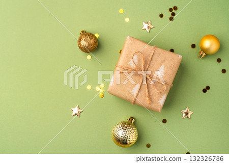 Christmas gift with ornaments on a green background Christmas gift with ornaments on a green background 132326786