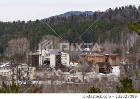 A tourist base nestled among the trees in the mountains in winter. 132327099