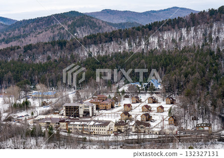A tourist base nestled among the trees in the mountains in winter. 132327131