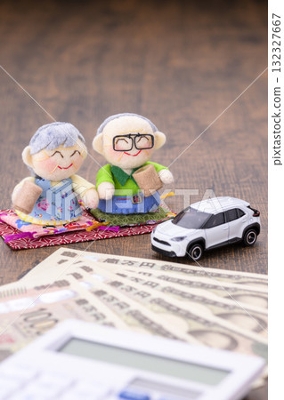 Elderly couple and their car (+ money and calculator) 132327667
