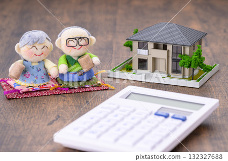 An elderly couple and their miniature house (+calculator) 132327688