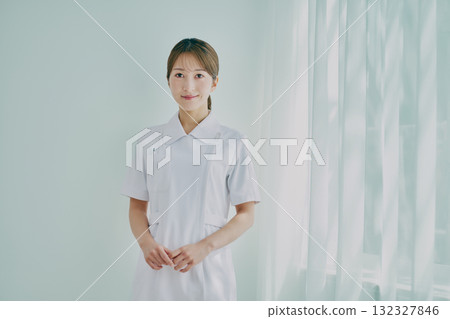 Female nurse standing by the window 132327846